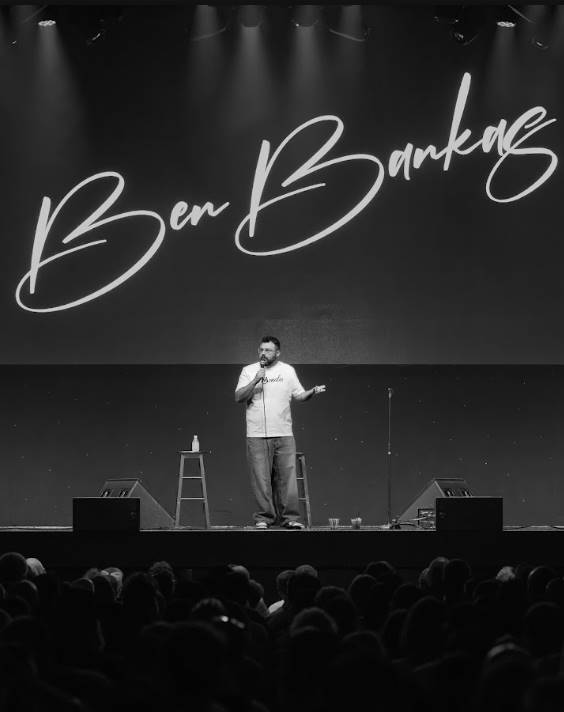 Ben Bankas performing stand-up comedy on stage