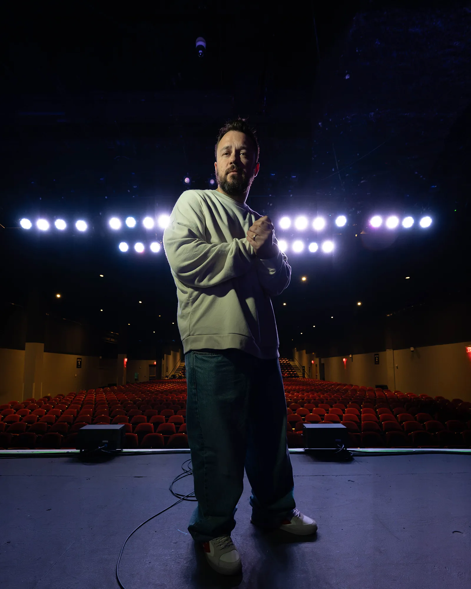 Ben Bankas performing under stage lights in Charles Town, West Virginia